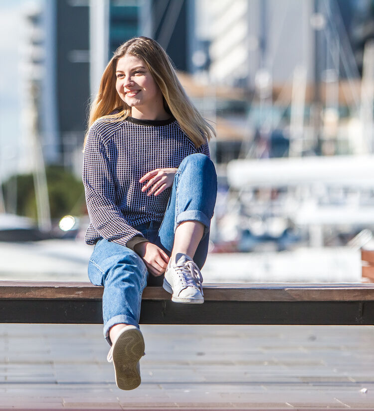 Girl Sitting on a Bench by the Harbour
