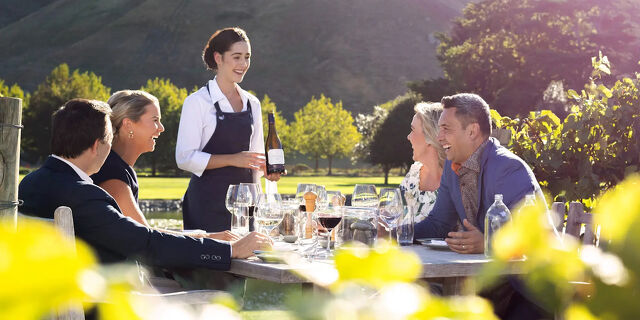 Lady Serving Wine in a Vineyard