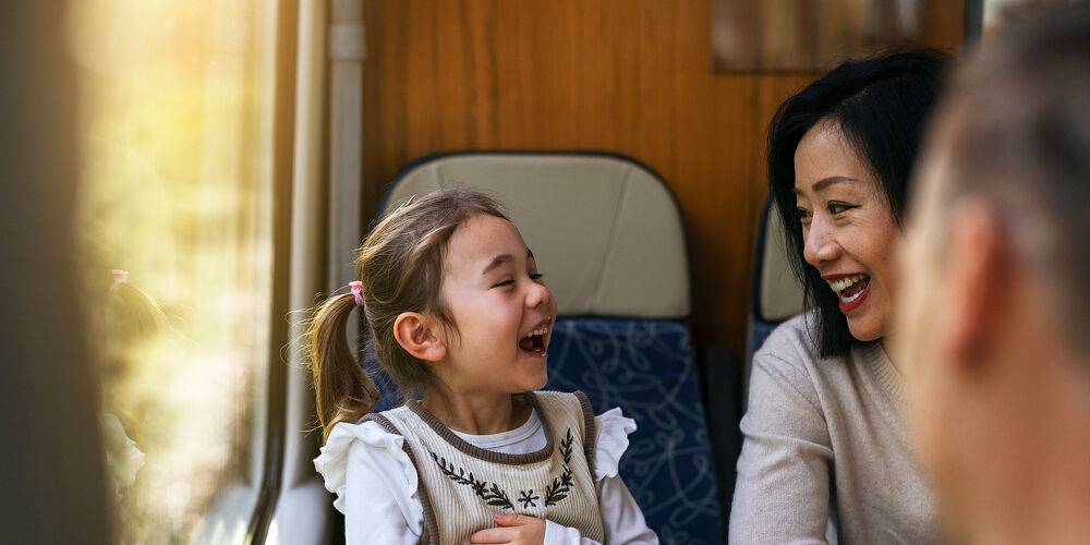 Family Pathways Mother and Daughter Laughing Together on a Train Ride Through Canterbury