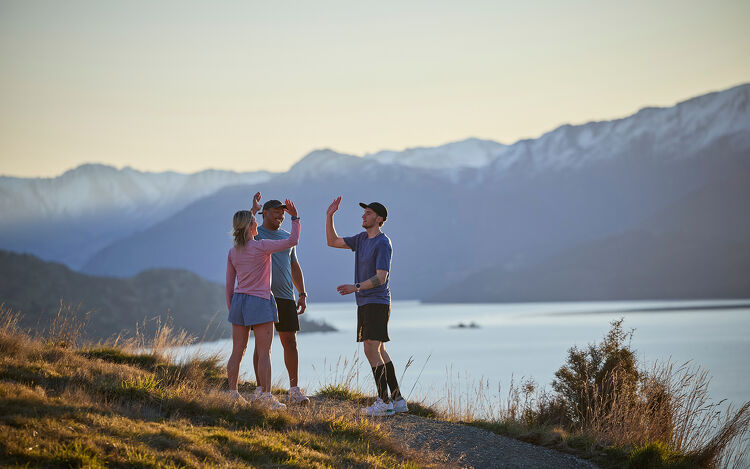 Three people hiking up a mountain